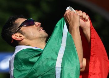 World Athletics Championships - Men's 35 Kilometres Race Walk - Eugene, Oregon, U.S. - July 24, 2022 Gold medallist Italy's Massimo Stano celebrates with a flag after winning the men's 35 kilometres race walk.
