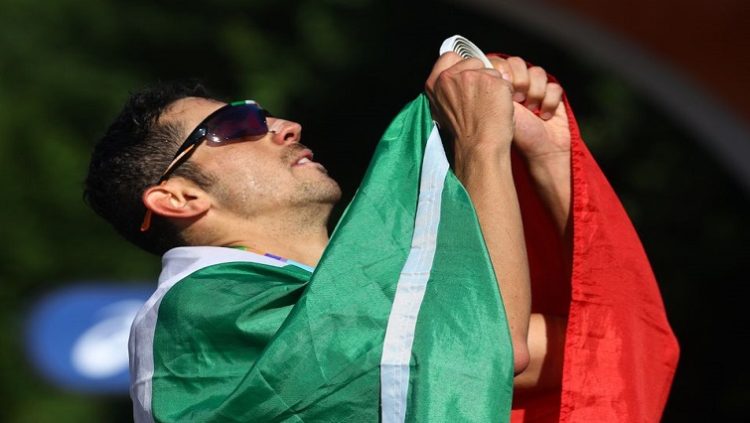 World Athletics Championships - Men's 35 Kilometres Race Walk - Eugene, Oregon, U.S. - July 24, 2022 Gold medallist Italy's Massimo Stano celebrates with a flag after winning the men's 35 kilometres race walk.