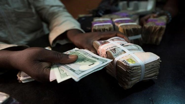 A trader changes dollars with naira at a currency exchange store in Lagos, Nigeria.