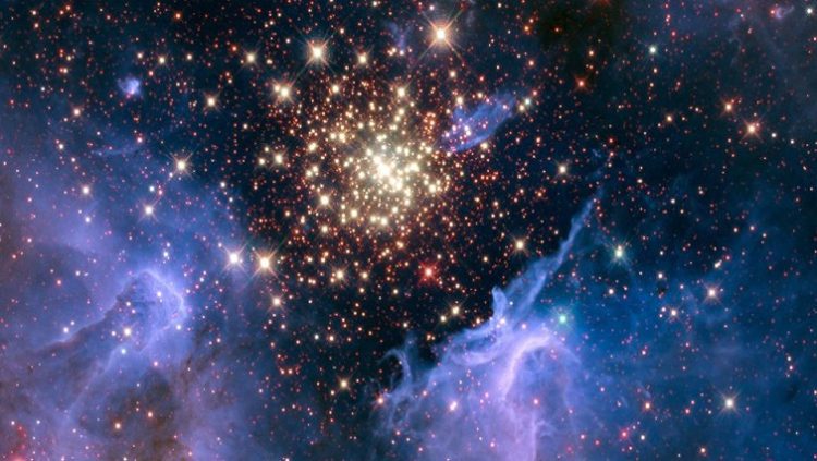 A cluster of young stars resembles an aerial burst, surrounded by clouds of interstellar gas and dust, in a nebula NGC 3603 located in the constellation Carina.