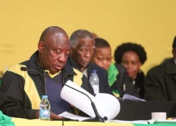 ANC President Cyril Ramaphosa looks over a document at the party's policy conference