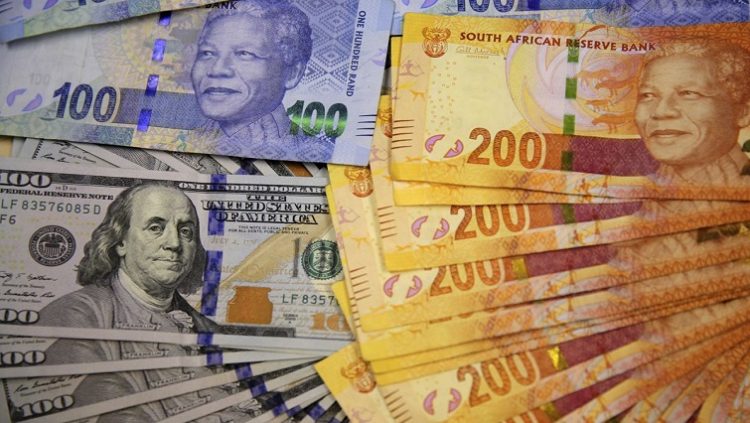 South African bank notes are displayed next to the American dollar notes in this photo illustration.