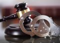 File image: Handcuffs and a court gavel.