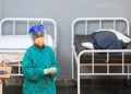 A health worker walks between beds at a temporary field hospital set up by Medecins Sans Frontieres (MSF) during the coronavirus disease (COVID-19) outbreak in Khayelitsha township near Cape Town, South Africa, July 21, 2020.
