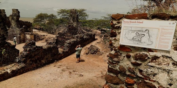 A tourist takes a photograph of ruins on the Kunta Kinte island in the Gambia River, Jufureh near Albreda, on the north bank of Gambia July 19, 2019.