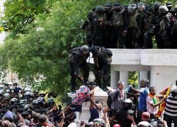 Security personnel push a man away as demonstrators gather outside the office of Sri Lanka's Prime Minister Ranil Wickremesinghe, amid the country's economic crisis, in Colombo, Sri Lanka July 13, 2022.