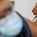 A medical worker administers a dose of the "Cominarty" Pfizer-BioNTech coronavirus disease (COVID-19) vaccine to a patient at a vaccination center in Ancenis-Saint-Gereon, France, November 17, 2021.