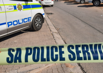 SAPS vehicles and police tape.
