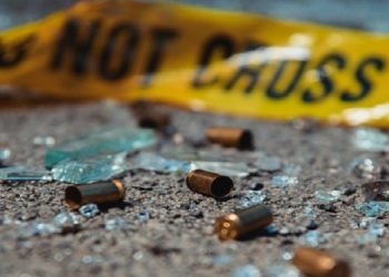 File image: Bullet casings and broken glass at a crime scene.