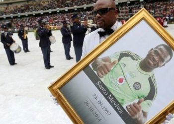 A man holds a framed picture of South African national soccer team goalkeeper and captain, Senzo Meyiwa during his funeral service in Durban November 1, 2014.