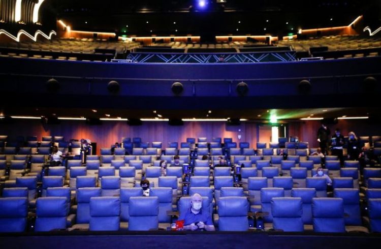 (File Image) People take their seats inside the Odeon Luxe Leicester Square cinema, on the opening day of the film "Tenet", amid the coronavirus disease (COVID-19) outbreak, in London, Britain.