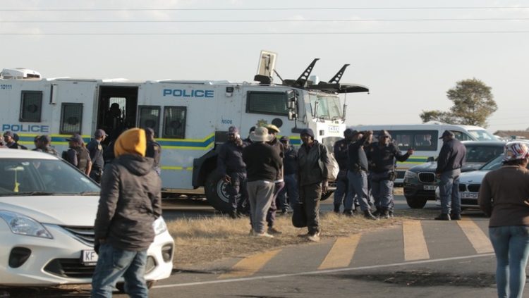 Police officers intervene during protests against illegal mining in Krugersdorp, August 4, 2022.