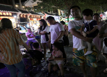 People are seen next to restaurants at Houhai village in Sanya, Hainan province, China
November26, 2020 Reuters