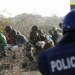 A police officer seen close to mineworkers during a protest in Marikana, North West.