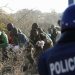 A policeman fires at protesting miners in Marikana, South Africa, August 16, 2012