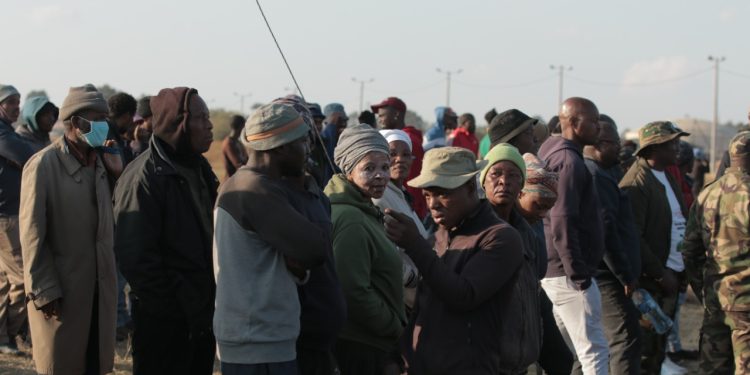 Kagiso residents gathering near a mine dump.