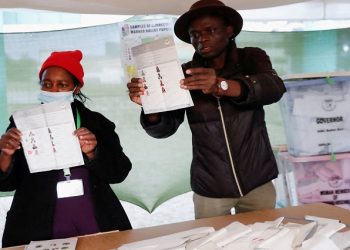 Electoral officials count cast ballot papers during the general election