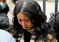 FILE PHOTO: Zhou Xiaoxuan, also known by her online name Xianzi, weeps as she arrives at a court for a sexual harassment case involving a Chinese state TV host, in Beijing, China December 2, 2020.