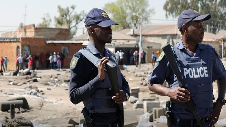 Two police officers seen patrolling an area after unrest.