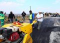 Workers seen fixing potholes in South Africa at the Operation Vala Zonke campaign launch.