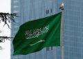 Flag of Saudi Arabia in front of a building.