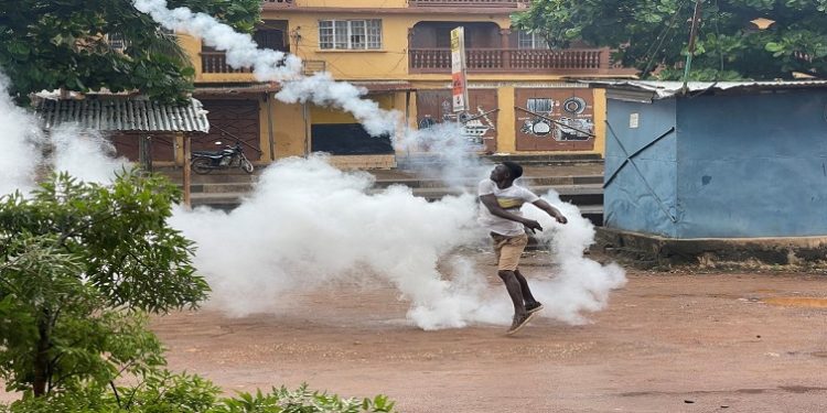 A demonstrator throws a gas canister during an anti-government protest, in Freetown, Sierra Leone, August 10, 2022