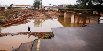 A man walks around a damaged bridge caused by flooding in Umlazi near Durban, South Africa, April 16, 2022.