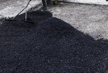 A person working on a tar road during the  Operation Vala Zonke launch.