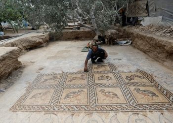 Palestinian farmer Salman al-Nabahin cleans a mosaic floor he discovered at his farm and which dates back to the Byzantine era, according to officials, in the central Gaza Strip September 18, 2022.