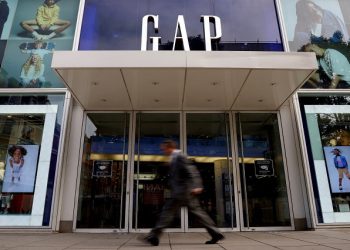 FILE PHOTO: A man walks past a Gap store on Oxford Street in London, Britain, July 1, 2021.