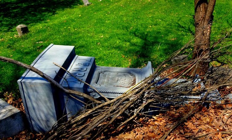 File Photo: A damaged tombstone at a grave