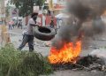 A demonstrator throws a tyre into a burning road block during protests over rising fuel prices and crime as inflation surged to its highest in a decade, in Port-au-Prince, Haiti September 13, 2022