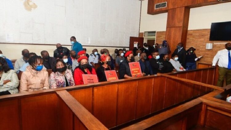 [File Image]: Members of the EFF with posters and Hillary Gardee’s family (front row) are seen inside the Nelspruit Magistrates’ Court in Mbombela on 09 May 2022.
