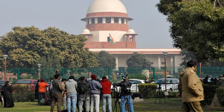 Television journalists are seen outside the premises of the Supreme Court in New Delhi, India, January 22, 2020
