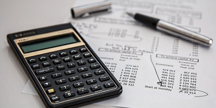 Pen, calculator and  financial statements seen on a table