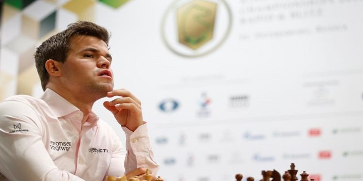 Magnus Carlsen of Norway sits in front of a chess board before a game,  2018 World Rapid and Blitz Chess Championships - Rapid Open - Saint Petersburg, Russia - December 26, 2018.