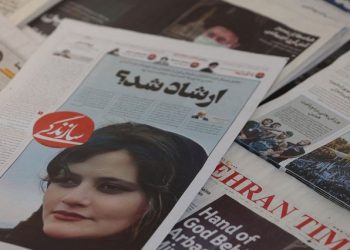 A newspaper with a cover picture of Mahsa Amini, a woman who died after being arrested by the Islamiv republic’s “morality police” is seen in Tehran, Iran September 18, 2022.