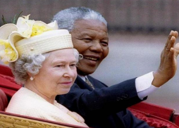 Nelson Mandela and Britain's Queen Elizabeth II ride in a carriage outside Buckingham Palace on the first day of a state visit to Britain, July 9, 1996.