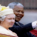 Nelson Mandela and Britain's Queen Elizabeth II ride in a carriage outside Buckingham Palace on the first day of a state visit to Britain, July 9, 1996.