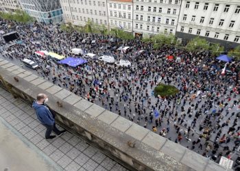 [File Photo] A man watches as demonstrators attend an anti-government protest in Prague, Czech Republic, on April 29, 2021.