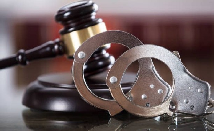 Handcuffs and gavel in a court.
