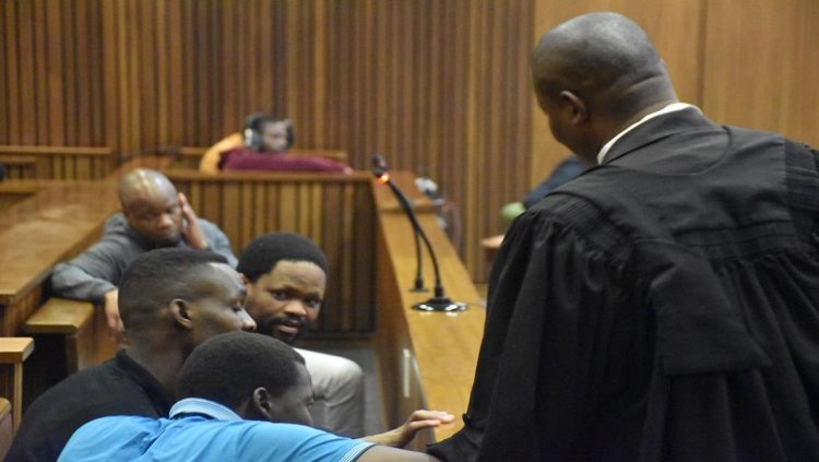 Adv. TT Thobane for accused 1 to 4 in the Senzo Meyiwa trial consults with his clients.
