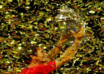 FILE PHOTO: [File Photo] Switzerland's Roger Federer celebrates with the trophy after winning the final against Australia's Alex de Minaur.