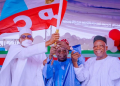 APC party's new presidential candidate Bola Tinubu raises a party's flag with Nigeria's President Muhammadu Buhari next to Abdullahi Adamu, the APC party chairperson, during the party convention in Abuja, Nigeria.
