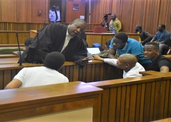Defense attorney TT Thobane speaks to the accused during the Senzo Meyiwa trial at the North Gauteng High Court in Pretoria, on 12 September 2022.