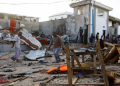 [File image] Bystanders walk through the scene of bombing at a seaside restaurant at Liido beach in Mogadishu, Somalia on 22 April 2022.