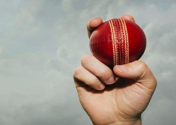 A player abut to bowl in a cricket match
