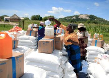 (File Image) Villagers collect food aid distributed by the World Food Program (WFP) following a prolonged drought in rural Mudzi district, Zimbabwe, February 20, 2020.