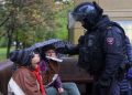 A person shows a passport to a Russian law enforcement officer during a rally, after opposition activists called for street protests against the mobilisation of reservists ordered by President Vladimir Putin, in Moscow, Russia September 24, 2022.