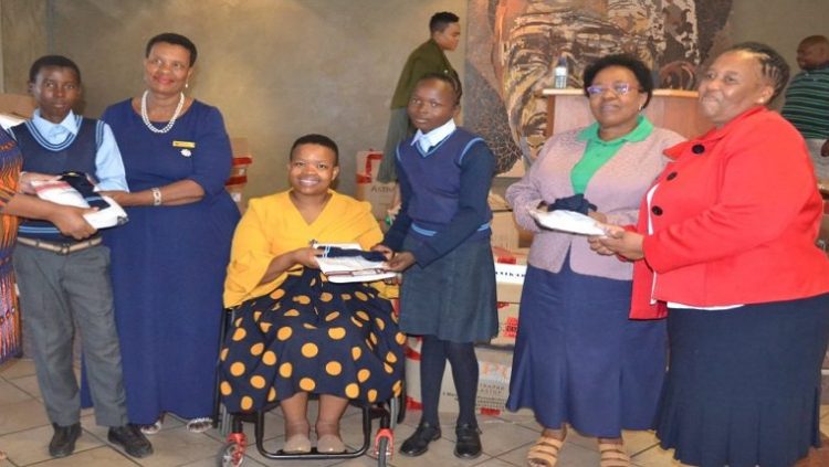 The Municipal Manager of Nkangala District Municipality (Centre) at an event to hand out school uniform and sanitary towels to various schools in the district.